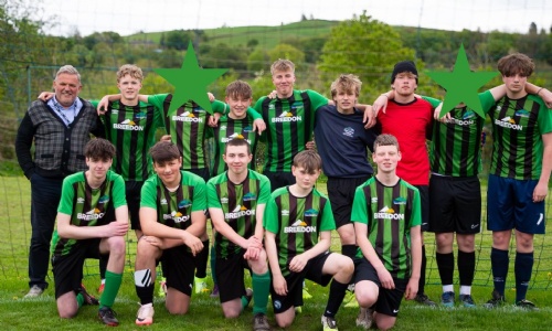 Key Stage 4 Boys Football Team smiling together on the pitch